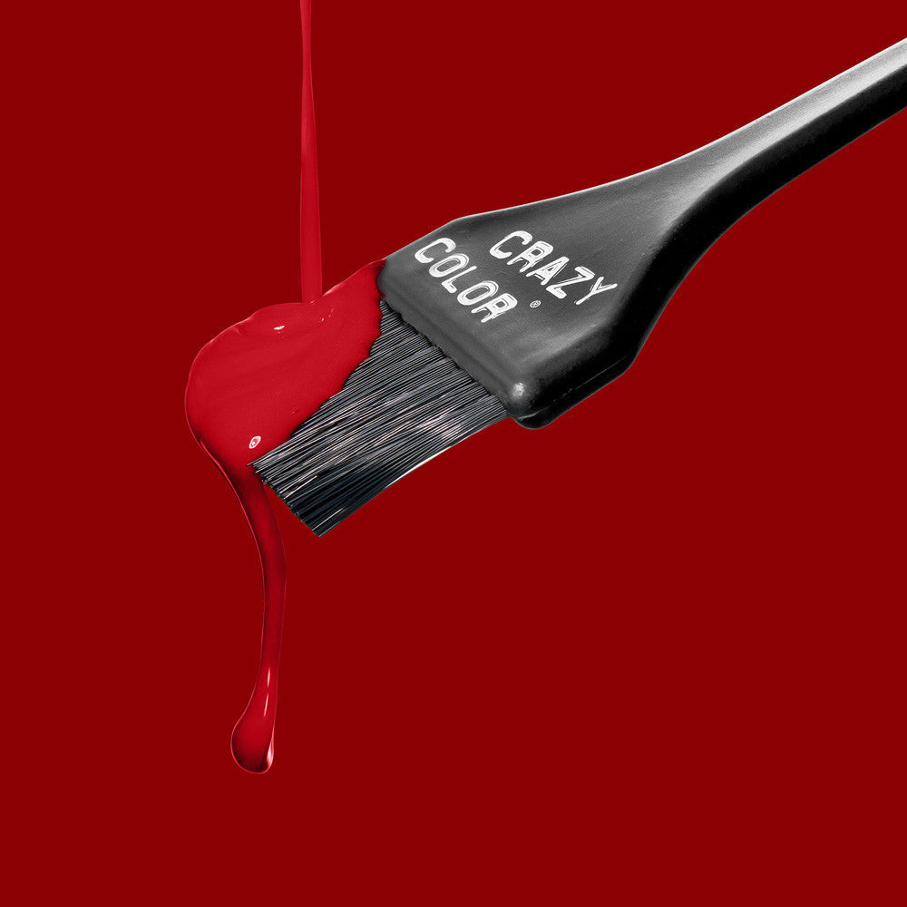 Hair dye brush with red color dripping on a red background, featuring the 'Crazy Color' brand by ABS France Wholesale.